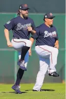  ?? CURTIS COMPTON/ATLANTA JOURNAL-CONSTITUTI­ON ?? Braves pitchers R.A. Dickey, left, and Bartolo Colon loosen up during a spring training workout.