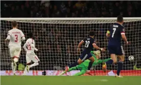  ?? Photograph: Matthew Ashton/AMA/Getty ?? Che Adams curls the ball past Denmark’s goalkeeper Kasper Schmeichel to double Scotland’s lead in the pulsating victory at Hampden.