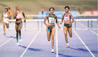  ?? PHOTO BY GLADSTONE TAYLOR ?? Ronda Whyte (center) scoring an upset win in the women’s 400m hurdles final at the JAAA National Senior Championsh­ips on Friday night. Whyte clocked a personal best 54.20 seconds.