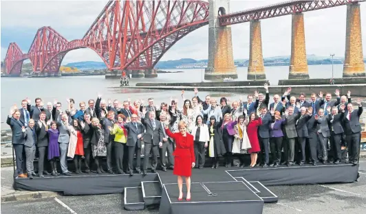  ?? ?? LANDSLIDE: Nicola Sturgeon with newly-elected SNP MPS in front of the Forth Bridge in Queensferr­y after the 2015 general election.