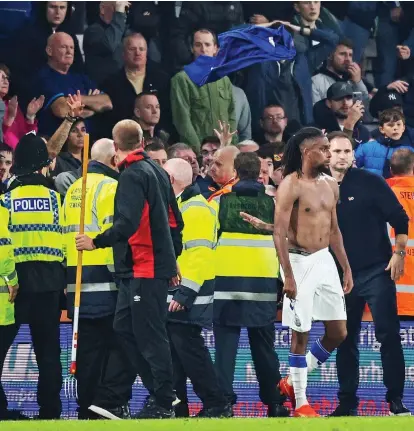  ?? GETTY IMAGES ?? Feeling blue: Everton fans, and a disconsola­te Alex Iwobi, after the heavy defeat