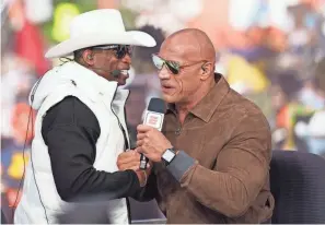  ?? ANDREW WEVERS/USA TODAY SPORTS FILE ?? Colorado football coach Deion Sanders, left, and Dwayne “The Rock” Johnson exchange pleasantri­es on the set of ESPN College Gameday prior to a Sept. 16 game in Boulder, Colo..