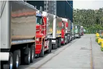  ?? STUFF ?? Trucks queue up at the Glencore Grain Ltd palm kernel processing facility at Port Taranaki.