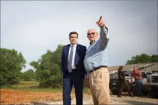  ?? Staff photo by Evan Lewis ?? U.S. Rep. John Ratcliffe, R-Heath, left, and Bowie County Judge James Carlow discuss the flood threat Thursday at a ranch near Texarkana. Ratcliffe briefly toured the area to receive updates on the situation.