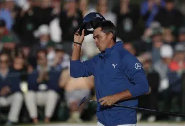  ?? MATT SLOCUM — THE ASSOCIATED PRESS ?? Rickie Fowler tips his hat on the 18th green during the second round of the Masters golf tournament Friday in Augusta, Ga.