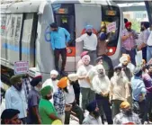  ??  ?? Sikhs stop a Metro train at Subhash Nagar in New Delhi on Wednesday during protest. — PTI