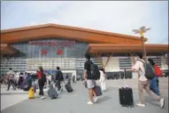  ?? KAIKEO SAIYASANE / XINHUA ?? Travelers enter the railway station in Vientiane, Laos, to take the China-Laos Railway on Nov 25.