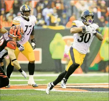  ?? Andy Lyons Getty Images ?? JAMES CONNER, Pittsburgh’s rookie running back, ran for 111 yards and two touchdowns Sunday at Cincinnati, his third such performanc­e in his team’s first six games. But he could sit when Le’Veon Bell comes back.