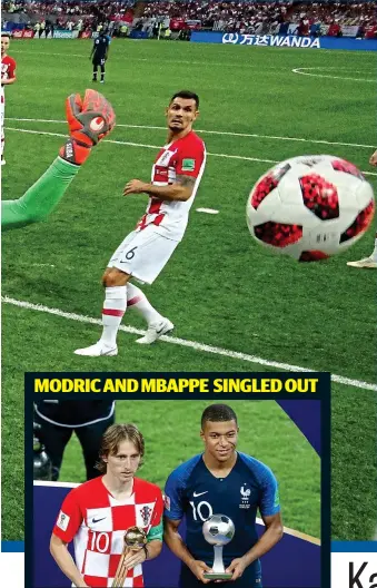  ??  ?? Gong show: Croatia’s Luka Modric (left) with the Golden Ball and France’s Kylian Mbappe with his Young player award