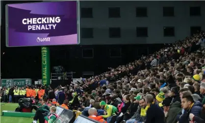  ??  ?? Spectators at Carrow Road wait for the VAR verdict in Norwich’s game against Manchester United.Photograph: Charlotte Wilson/Offside via Getty Images