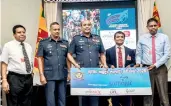  ??  ?? Mohammed Rizvi, Executive Director, Softlogic, handing over the main sponsorshi­p cheque to the Commander of the Air Force Air Marshall, Sumangala Dias with the officials