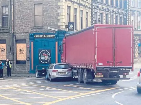  ??  ?? ACCIDENT: The damaged Volkswagen Passat and the lorry at the crash scene in Meadowside, Dundee, on Saturday.