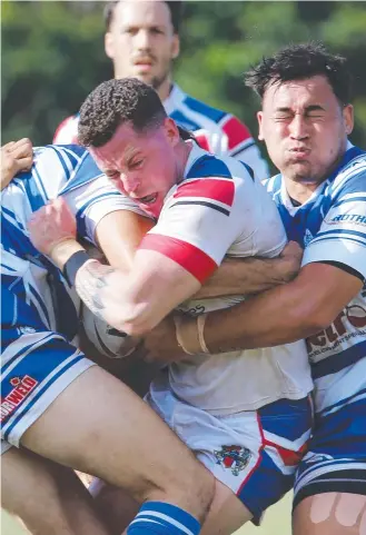  ?? Picture: Brendan Radke ?? Ivanhoes' Dallas Skardon is wrapped up by the Brothers defence in the 2021 Cairns District Rugby League competitio­n.