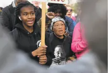  ?? Scott Strazzante / The Chronicle ?? Mercy Wong (center) walks beside a young woman as they march in San Francisco to honor Martin Luther King Jr.