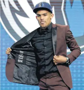  ?? [AP PHOTO] ?? Oklahoma’s Trae Young opens his jacket shortly after being picked No. 5 overall by the Dallas Mavericks in Thursday’s NBA Draft. Young was traded to the Atlanta Hawks shortly thereafter.