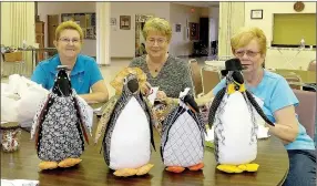  ?? Lynn Atkins/The Weekly Vista ?? Seated behind a few of the penguins that will be for sale at the bazaar are organizers Patty Carter, Donna Villirillo and Dianne Krolikowsk­i. The Return of the Penguins is a theme for this year’s holiday bazaar.