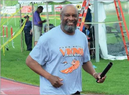  ?? COURTESY OF TED HODGINS ?? Ron Livers smiles as he jogs around the track at the Pioneer Athletic Conference Championsh­ips at Boyertown in 2013. The former world class track and field athlete from Norristown who recently served as jumps coach at Perkiomen Valley died on Dec. 19.