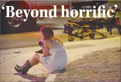  ?? AP PHOTO ?? A woman sits on a curb at the scene of a shooting outside of a music festival along the Las Vegas Strip. Multiple victims were being transporte­d to hospitals after a shooting late Sunday at a music festival.