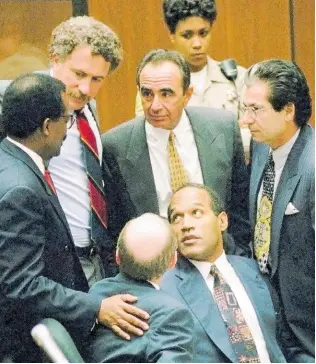  ?? ?? Defendant O.J. Simpson is surrounded by his defence attorneys, from left, Johnnie L. Cochran Jr, Peter Neufeld, Robert Shapiro, Robert Kardashian, and Robert Blasier, seated at left, at the close of defence arguments in his murder trial, Thursday, September 28, 1995, in Los Angeles.