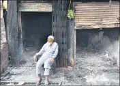  ??  ?? An elderly man sits outside shops burnt in the riots at Shiv Vihar in New Delhi on March 15. SANCHIT KHANNA/HT PHOTO