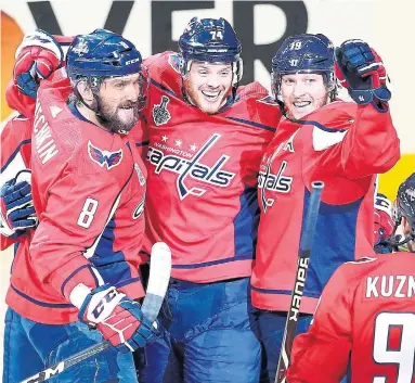  ?? AVI GERVER/GETTY IMAGES ?? Capitals Alex Ovechkin, John Carlson and Nicklas Backstrom celebrate Carlson’s second-period goal in Monday night’s Game 5 of the Stanley Cup final. The Caps can wrap up the Cup in Vegas on Thursday night.