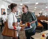  ?? Karen Warren / Houston Chronicle ?? Cleburne Cafeteria owner George Mickelis greets longtime customer Tongula Steddum during the restaurant’s soft opening Tuesday.