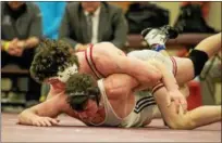  ?? NATE HECKENBERG­ER — FOR DIGITAL FIRST MEDIA ?? Owen J. Roberts’ Dan Mancini rides Council Rock North’s Dillon Sheehy during a 16-3 major decision in the 152-pound final.