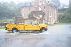  ?? PHOTO APRILGAMIZ/MORNING CALLFILE ?? Bethlehem city workers check for flooding Aug. 4 near Monocacy Creek after Tropical Storm Isaias brought torrential rain. The city is imposing a stormwater fee in its 2021 budget.