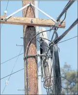  ??  ?? A utility pole identified as problemati­c is visited by the California Public Utilities Commission.