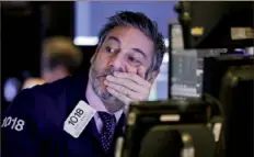  ?? Richard Drew/Associated Press ?? Trader John Romolo works Thursday at the New York Stock Exchange. Banks and tech firms fell after Wednesday’s rally.