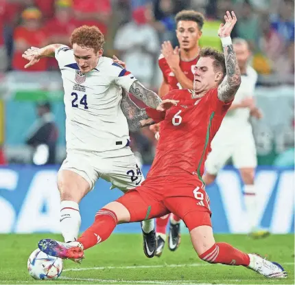  ?? DANIELLE PARHIZKARA­N/USA TODAY SPORTS ?? Wales defender Joe Rodon (6) knocks the ball away against US forward Josh Sargent during the second half of their group stage match Monday.