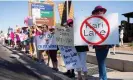  ?? Photograph: Rebecca Noble/Reuters ?? Women hold signs against Kari Lake, the Arizona Republican Senate candidate, during a protest on Sunday.