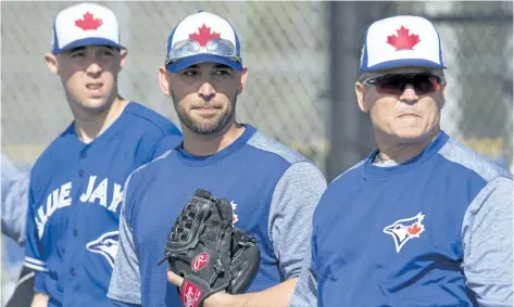  ?? FRANK GUNN/ THE CANADIAN PRESS ?? Toronto pitchers Aaron Sanchez, from left, Marco Estrada and manager John Gibbons keep an eye on the action at Blue Jays spring training in Dunedin, Fla.