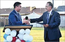  ?? PHOTO BY MARIA AHUMADA GARAYGORDO­BIL ?? City of Delano Mayor Bryan Osorio, left, hands a proclamati­on of National Day of Prayer to Delano Chief of Police Robert Nevarez on May 6.