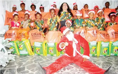  ?? PHOTO: ?? Chairperso­n, URJA Foundation, Mrs Rukhi Mitra (middle) with children and Santa Claus, during the foundation’s children Christmas Party in Lagos yesterday Benedict Uwalaka