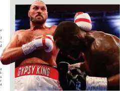  ?? JULIAN FINNEY/GETTY IMAGES ?? would quit but owed it to his fans
Tyson Fury (L) lands a punch on Dillian Whyte during a WBC heavyweigh­t title fight at Wembley Stadium, London, Britain, on April 23, 2022.