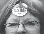  ?? JUSTIN TANG / THE CANADIAN PRESS ?? Shirley Taylor wears a ‘Burnt by Phoenix’ sticker on her forehead during a rally in Ottawa earlier this year.