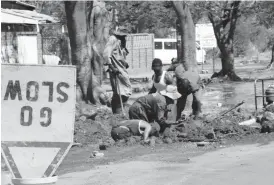  ??  ?? MEN AT WORK . . . Bulawayo City Council continues to lose a lot of treated water through leaking pipes. The picture taken yesterday in the city centre shows workmen attending to a burst pipe