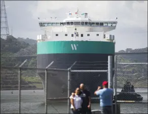  ?? (AP/Agustin Herrera) ?? A cargo ship is guided through the Panama Canal in Panama City on Wednesday.