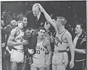  ?? AP ?? Michigan coach Dave Strack is carried off the floor by his players after a win in the 1964 NCAA tournament.