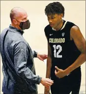  ?? PETE CASTER — THE ASSOCIATED PRESS ?? Colorado coach Tad Boyle talks with Jabari Walker. At No. 16, it is the highest-ranked team in the Pac-12 in NET.