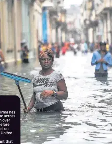  ??  ?? UNDER WATER Residents of Cuba walk the flooded streets after Hurricane Irma struck. Pic: Getty