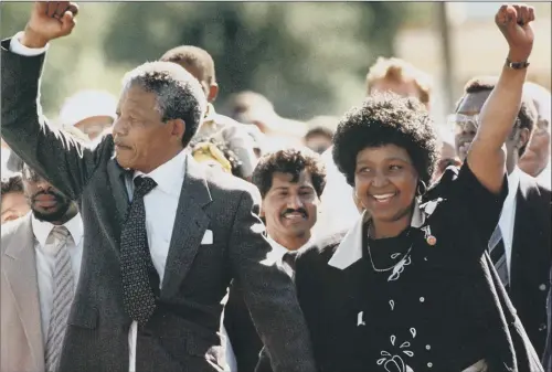  ?? PICTURE: AP. ?? Nelson Mandela and his wife Winnie walk hand in hand after his release in 1990 from 27 years in prison, heralding the end of apartheid in South Africa. FREEDOM: