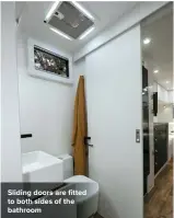  ??  ?? Sliding doors are fitted to both sides of the bathroom