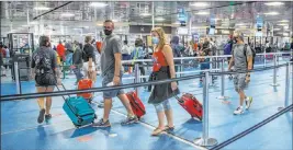  ?? L.E. Baskow Las Vegas Review-journal @Left_eye_images ?? Becky Esquivel, a union official who represents TSA workers, says that even with new safety measures at airports, some passengers still present issues to officers, especially when it comes to mask wearing or wearing them properly.