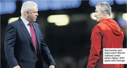  ??  ?? Rob Howley and head coach Warren Gatland confer before Wales’ 2017 game with Georgia
