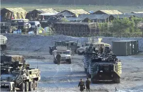  ??  ?? CAPAS TOWN: This file photo taken on April 14, 2016 shows US marines walking next to their transport and amphibious vehicles at a temporary camp for the “Balikatan” joint US-Philippine military exercise at Crow Valley. — AFP