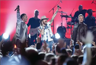  ?? Associated Press photo ?? Nick Carter, at right, of Backstreet Boys, and from left, Tyler Hubbard and Brian Kelley, of Florida Georgia Line, perform at the 52nd annual Academy of Country Music Awards at the T-Mobile Arena on Sunday night in Las Vegas.