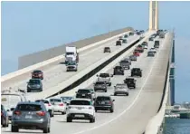  ?? ?? Traffic streams over the bridge on July 21, 2021, in St. Petersburg, where the new suicide prevention barrier was completed.