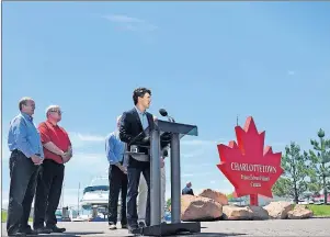  ?? NATHAN ROCHFORD/THE GUARDIAN ?? Egmont MP Bobby Morrissey, left, and Cardigan MP Lawrence MacAulay, listen as Prime Minister Justin Trudeau speaks to reporters during a news conference at the Port of Charlottet­own last week.